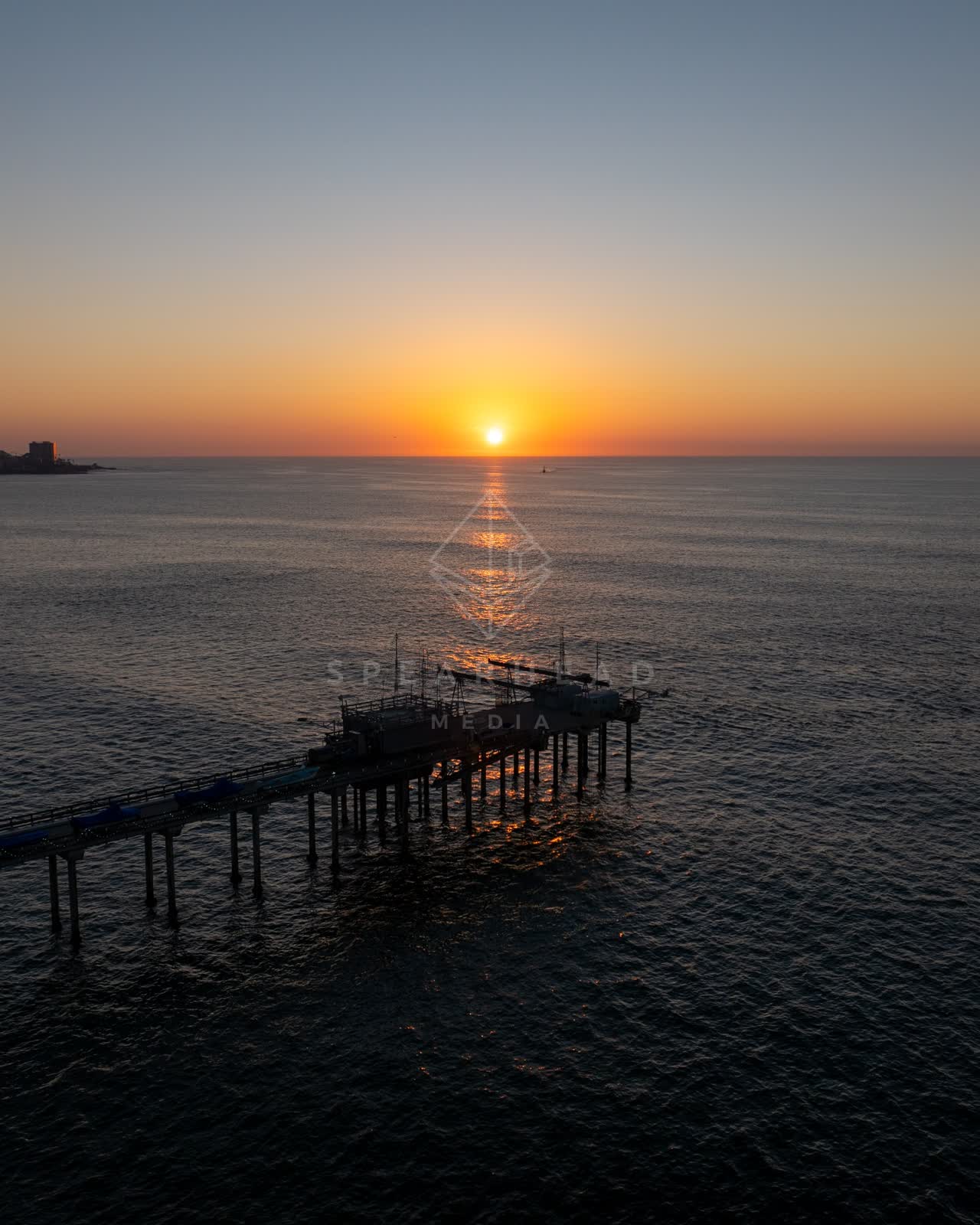 Low aerial view of the beach, the pier and the ocean at La Jolla Shores.