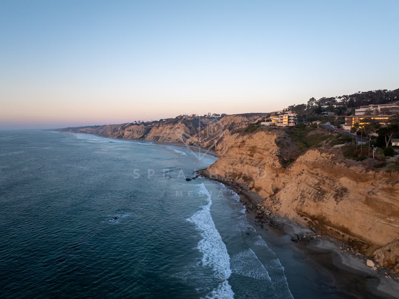 Aerial view of the cliffs, the surf and the ocean at La Jolla Shores.