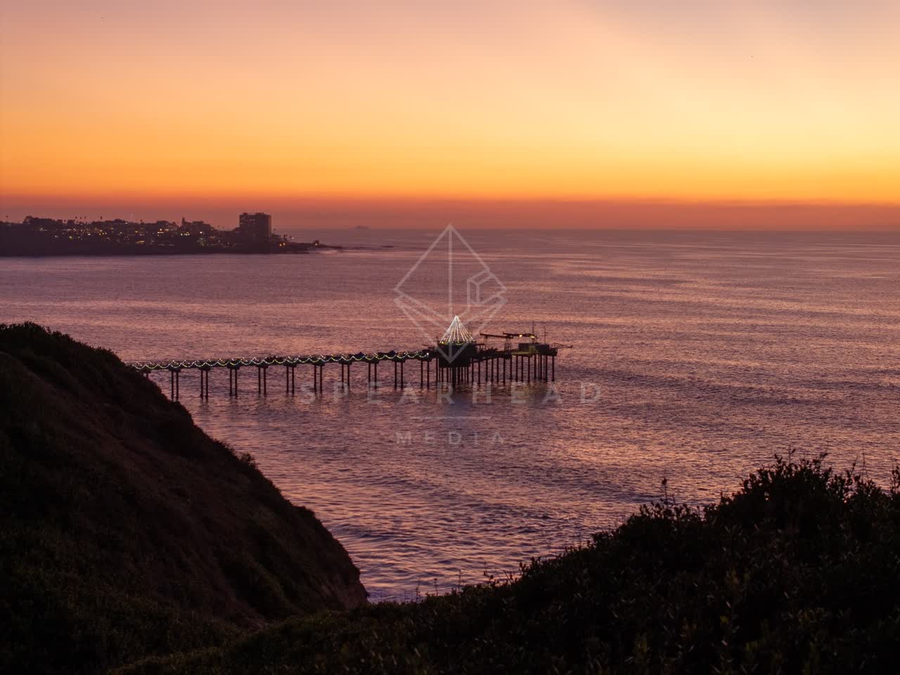 Elevated view of the cliffs, the pier and the ocean at La Jolla Shores.