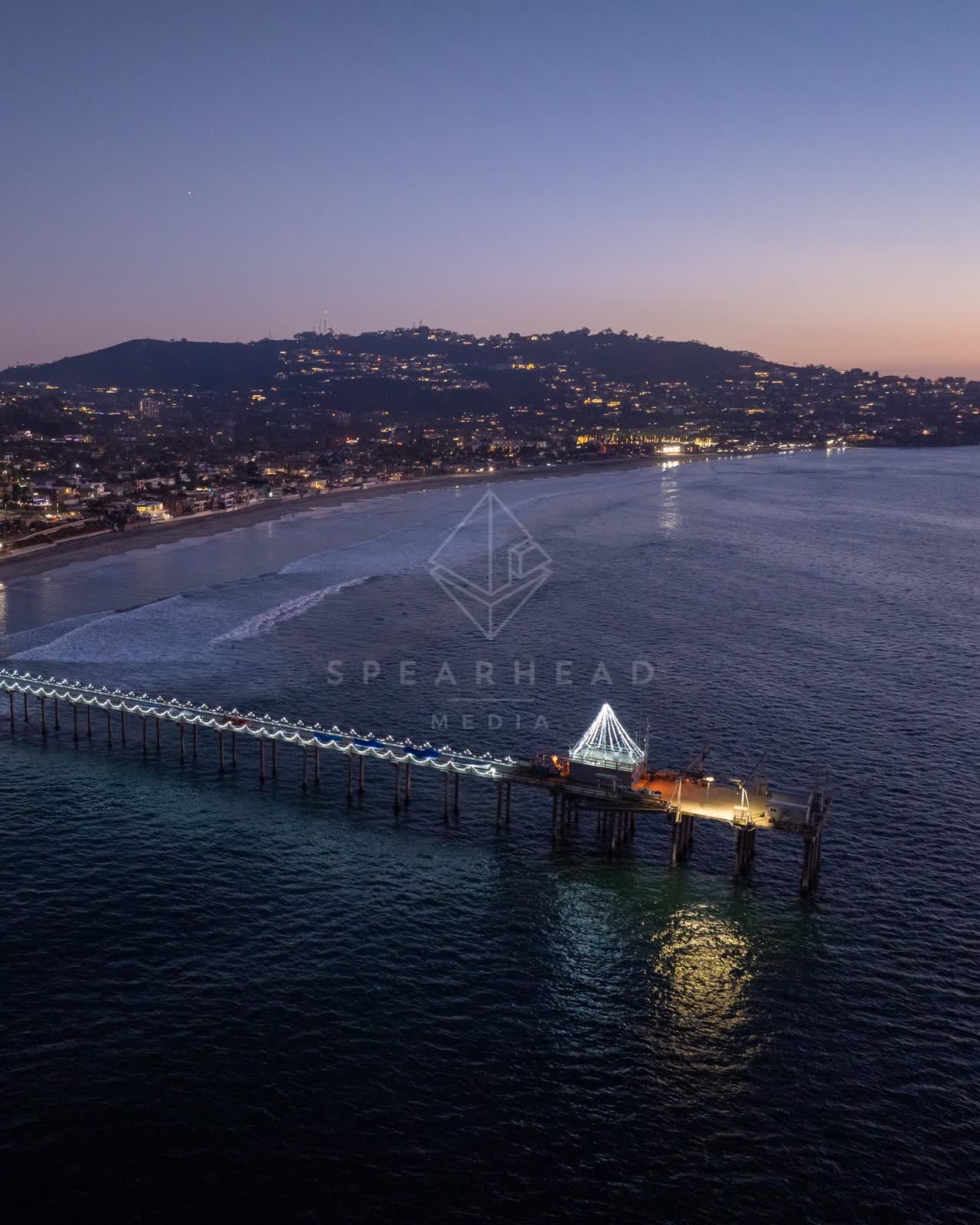 Aerial view of the beach, the surf and the pier at La Jolla Shores.