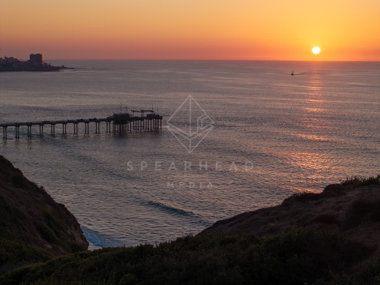Elevated view of the cliffs, the pier and the ocean at La Jolla Shores.