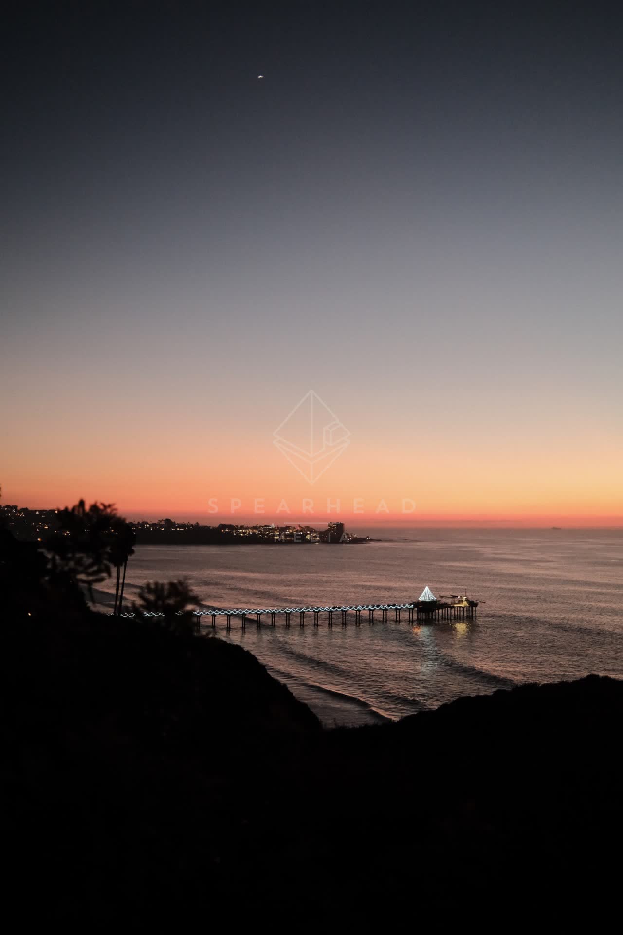 Elevated view of the cliffs, the pier and the ocean at La Jolla Shores.
