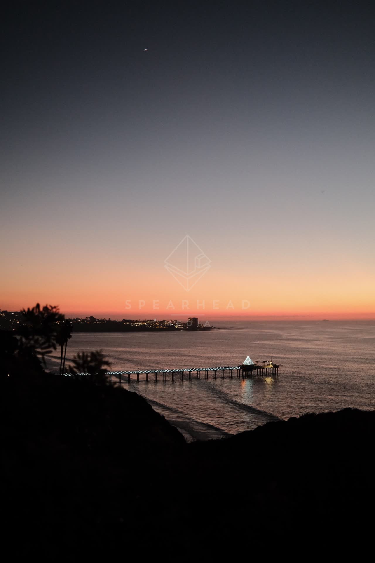 Elevated view of the cliffs, the pier and the ocean at La Jolla Shores.
