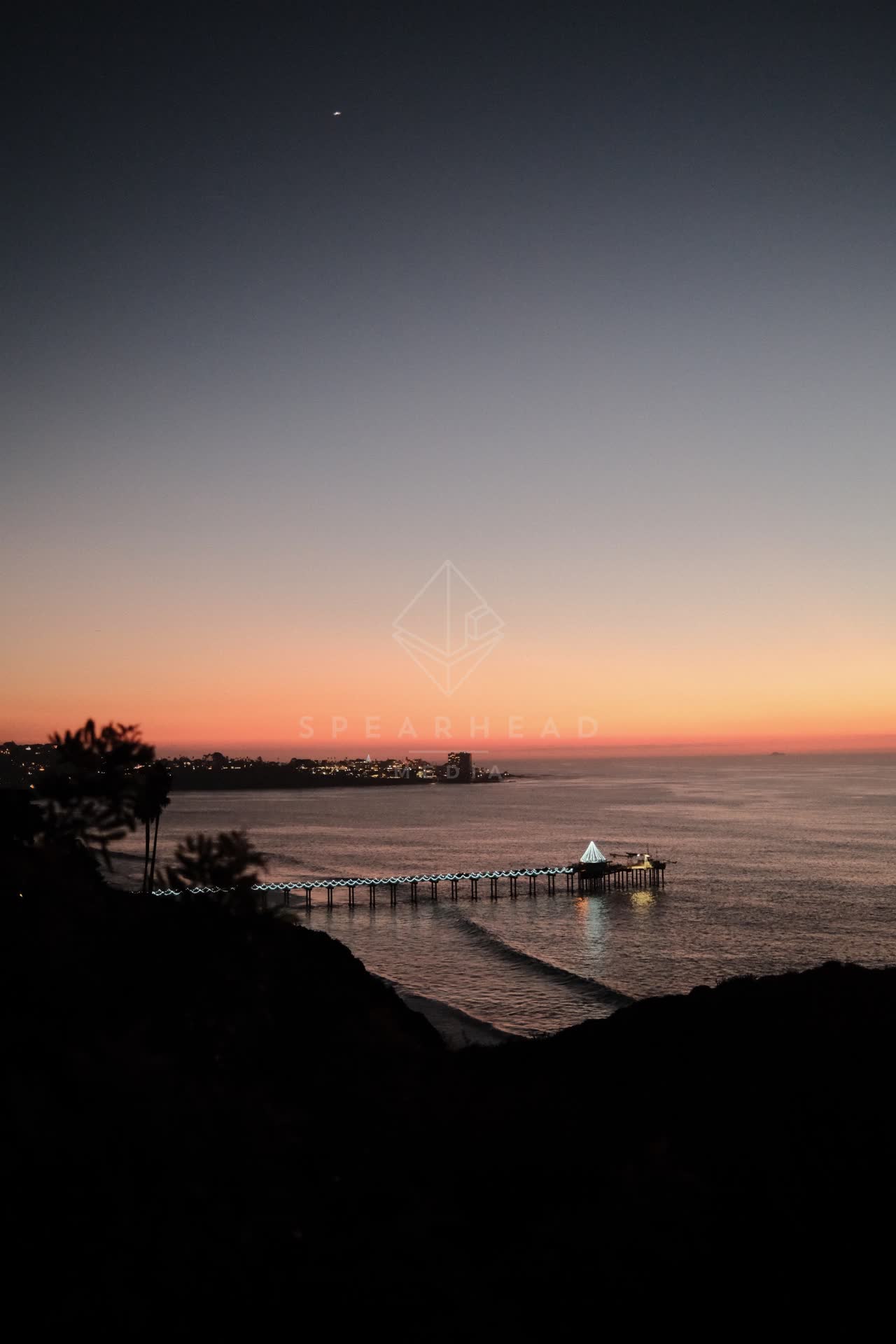 Elevated view of the cliffs, the pier and the ocean at La Jolla Shores.