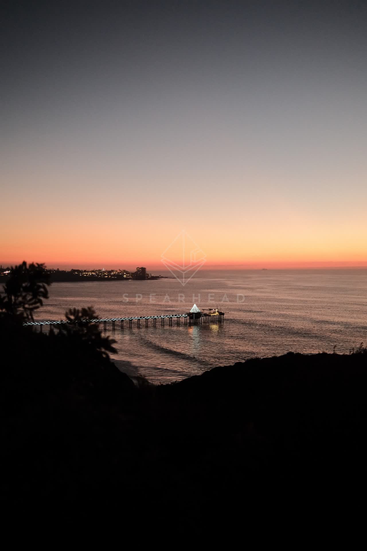 Elevated view of the cliffs, the pier and the ocean at La Jolla Shores.