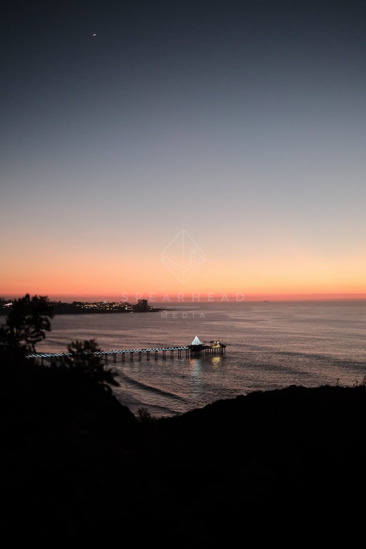 Elevated view of the cliffs, the pier and the ocean at La Jolla Shores.