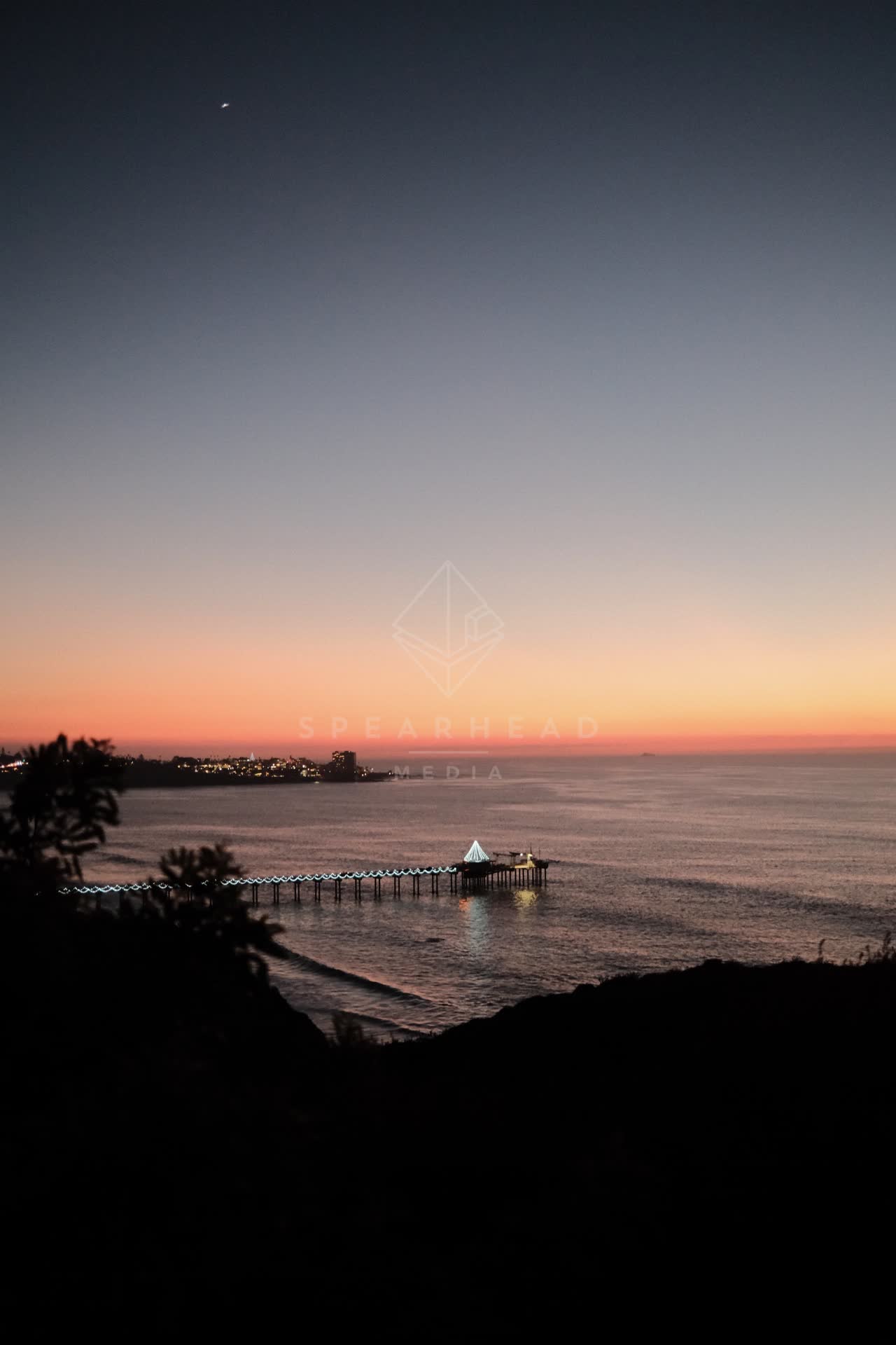 Elevated view of the cliffs, the pier and the ocean at La Jolla Shores.