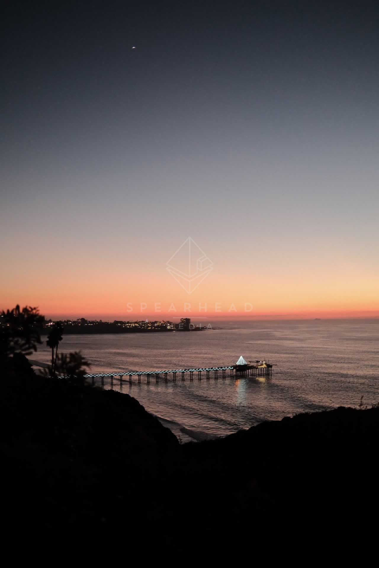 Elevated view of the cliffs, the pier and the ocean at La Jolla Shores.