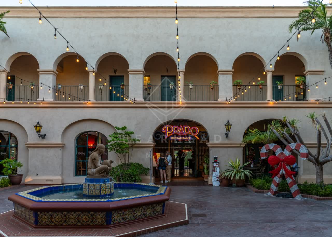 A park, the buildings and open country in Balboa Park, with people walking.