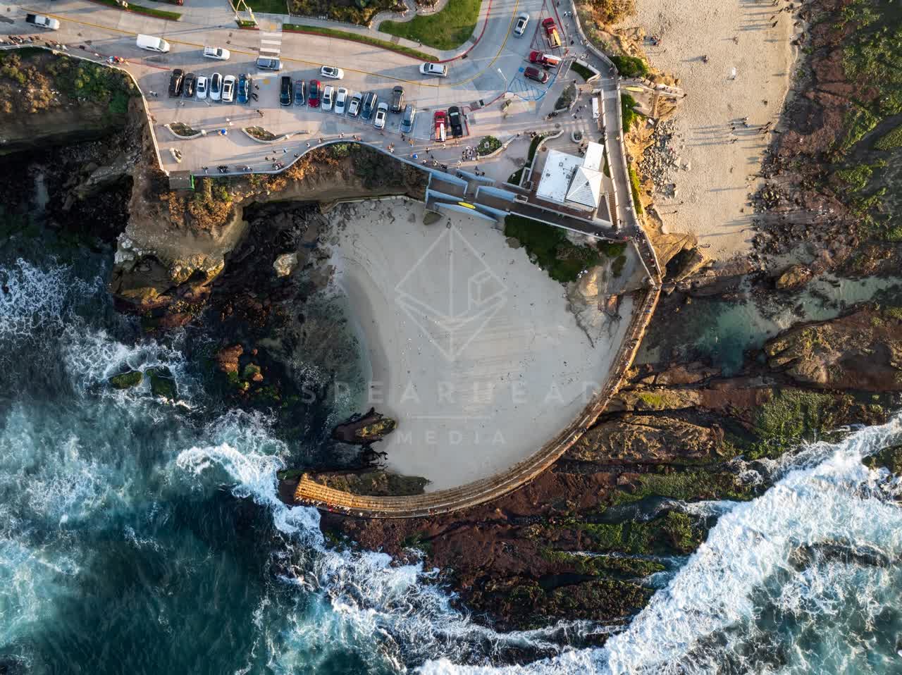 Aerial view of the cliffs, the surf and the ocean at La Jolla Cove.