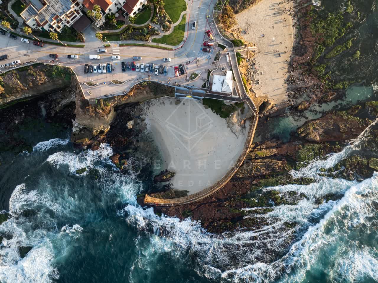 Aerial view of the cliffs, the surf and the ocean at La Jolla Cove.