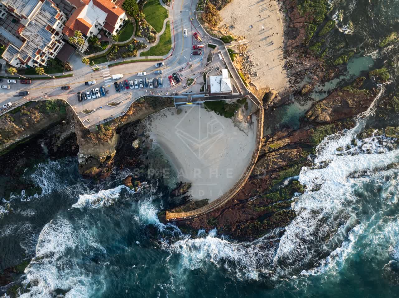 Aerial view of the cliffs, the surf and the ocean at La Jolla Cove.