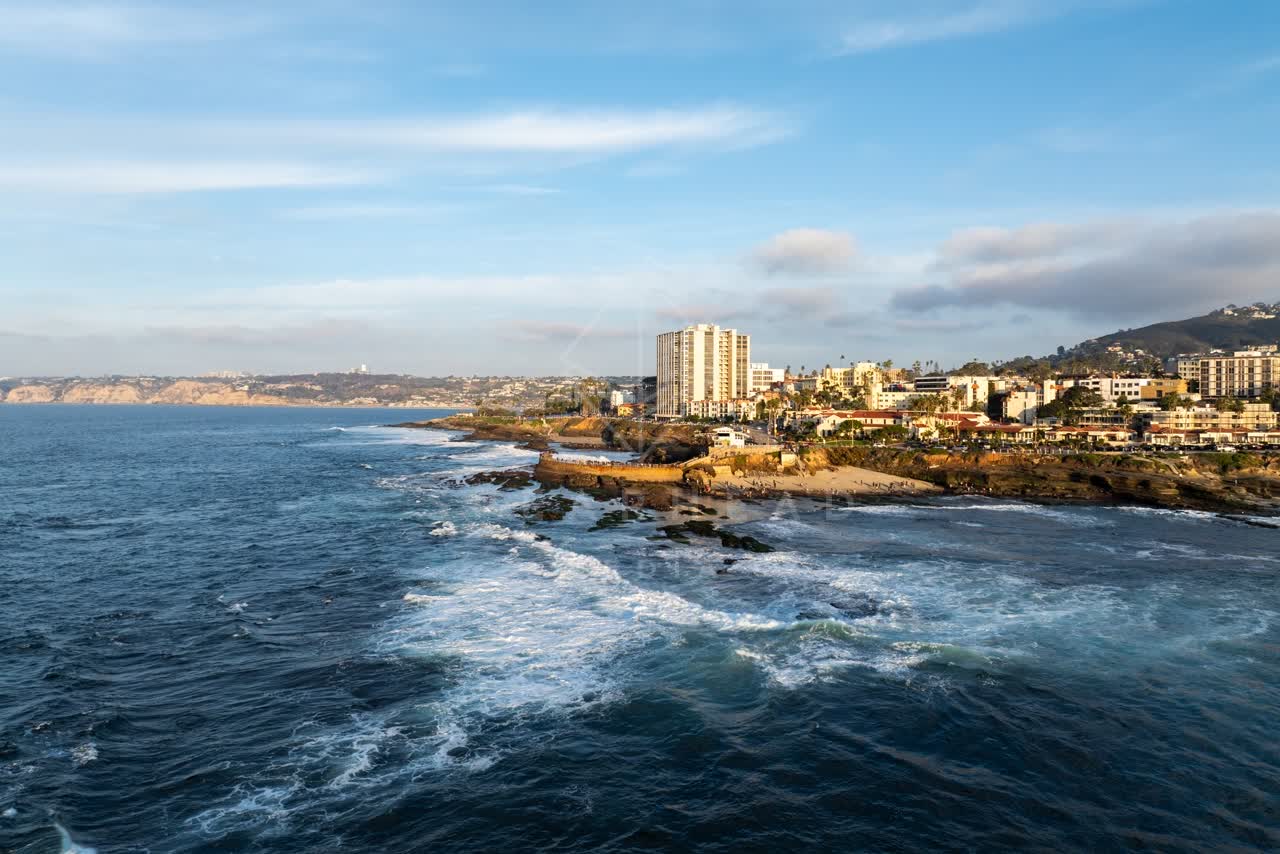 Aerial view of the cliffs, the surf and the ocean at La Jolla Cove.