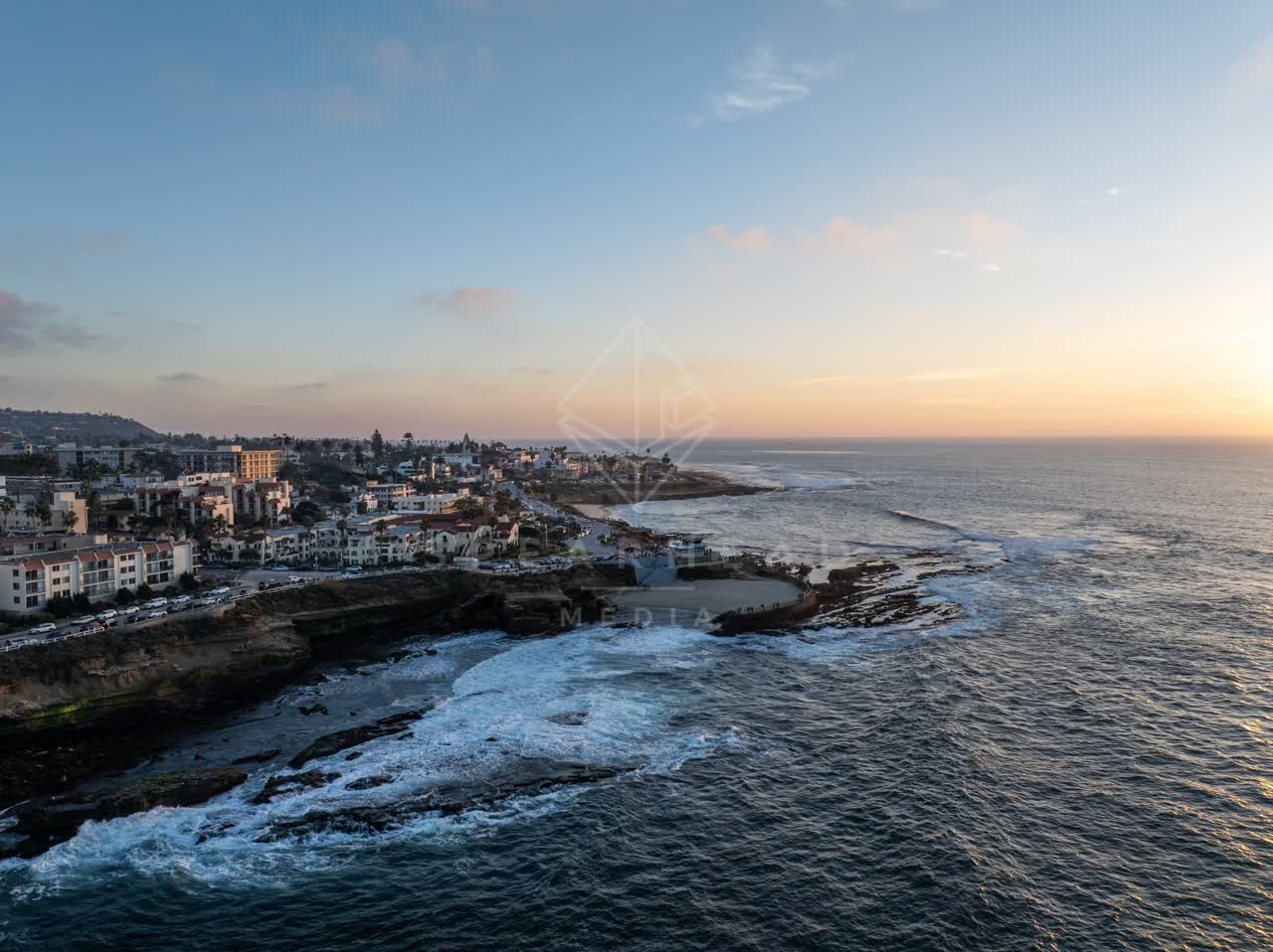 Aerial view of the cliffs, the surf and the ocean at La Jolla Cove.