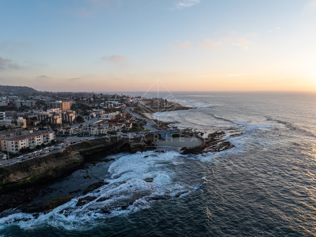 Aerial view of the cliffs, the surf and the ocean at La Jolla Cove.