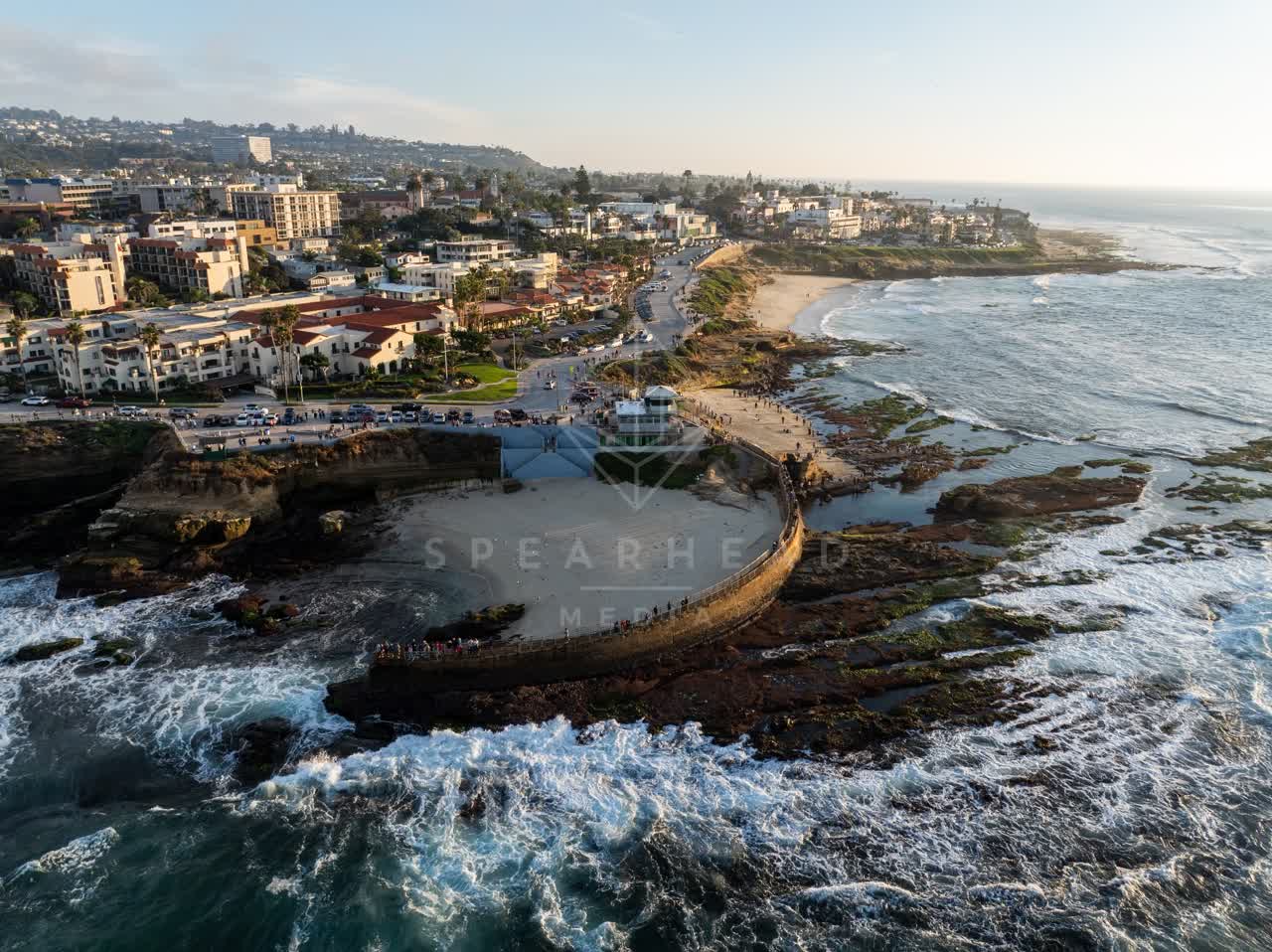 Aerial view of the cliffs, the surf and boats at La Jolla Cove.
