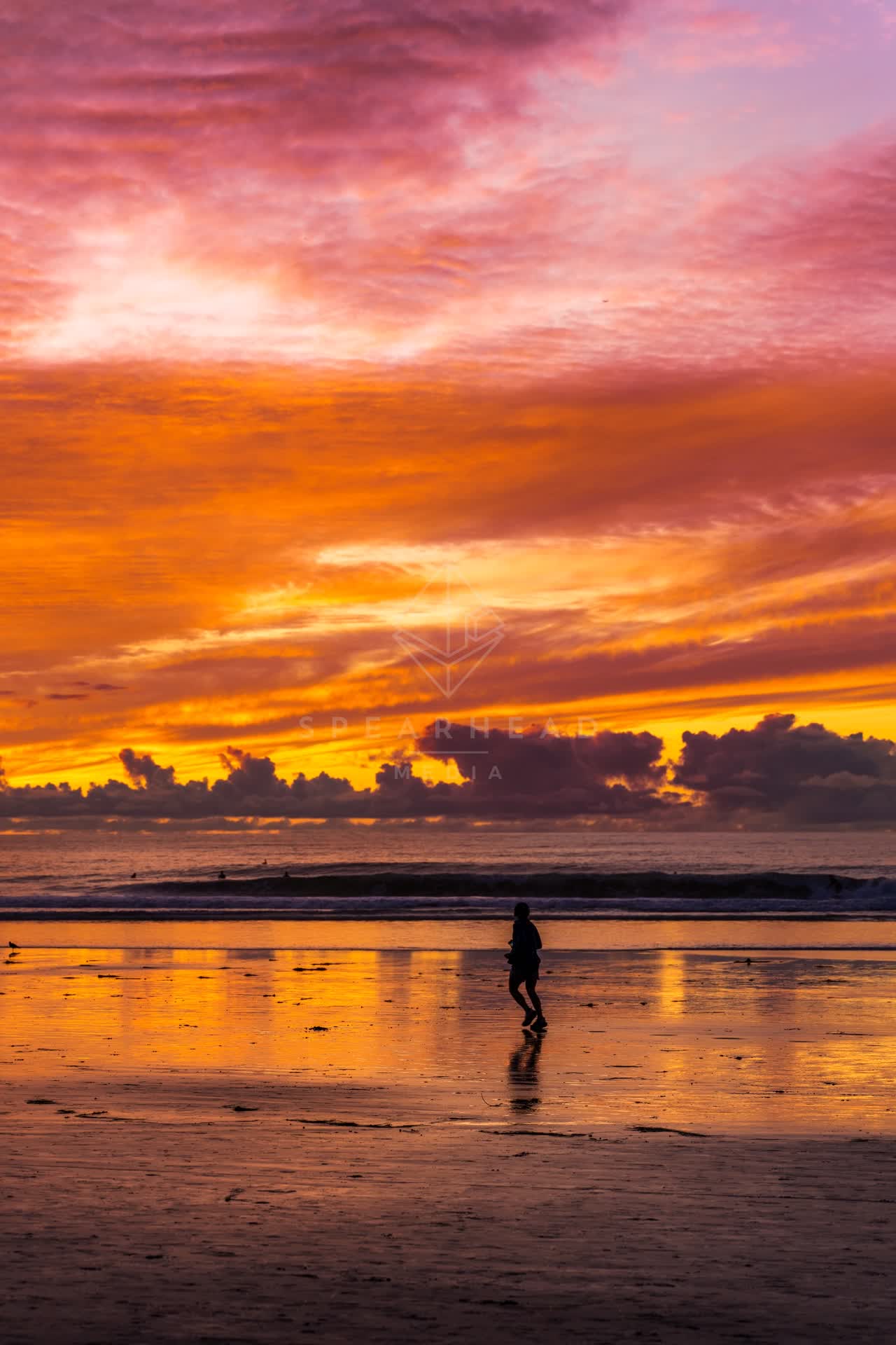 The beach, the surf and the ocean at La Jolla Shores, with people walking.