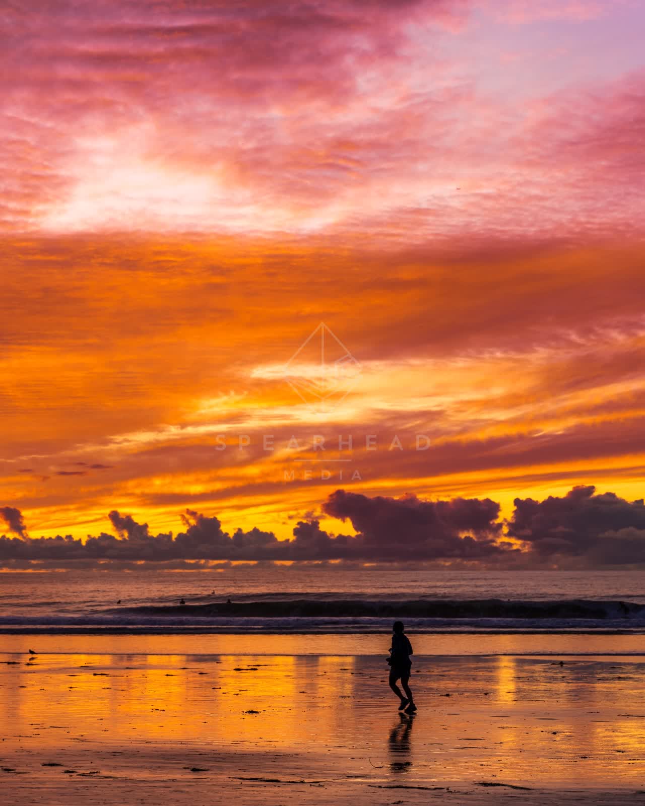 The beach, the surf and the ocean at La Jolla Shores, with people walking.