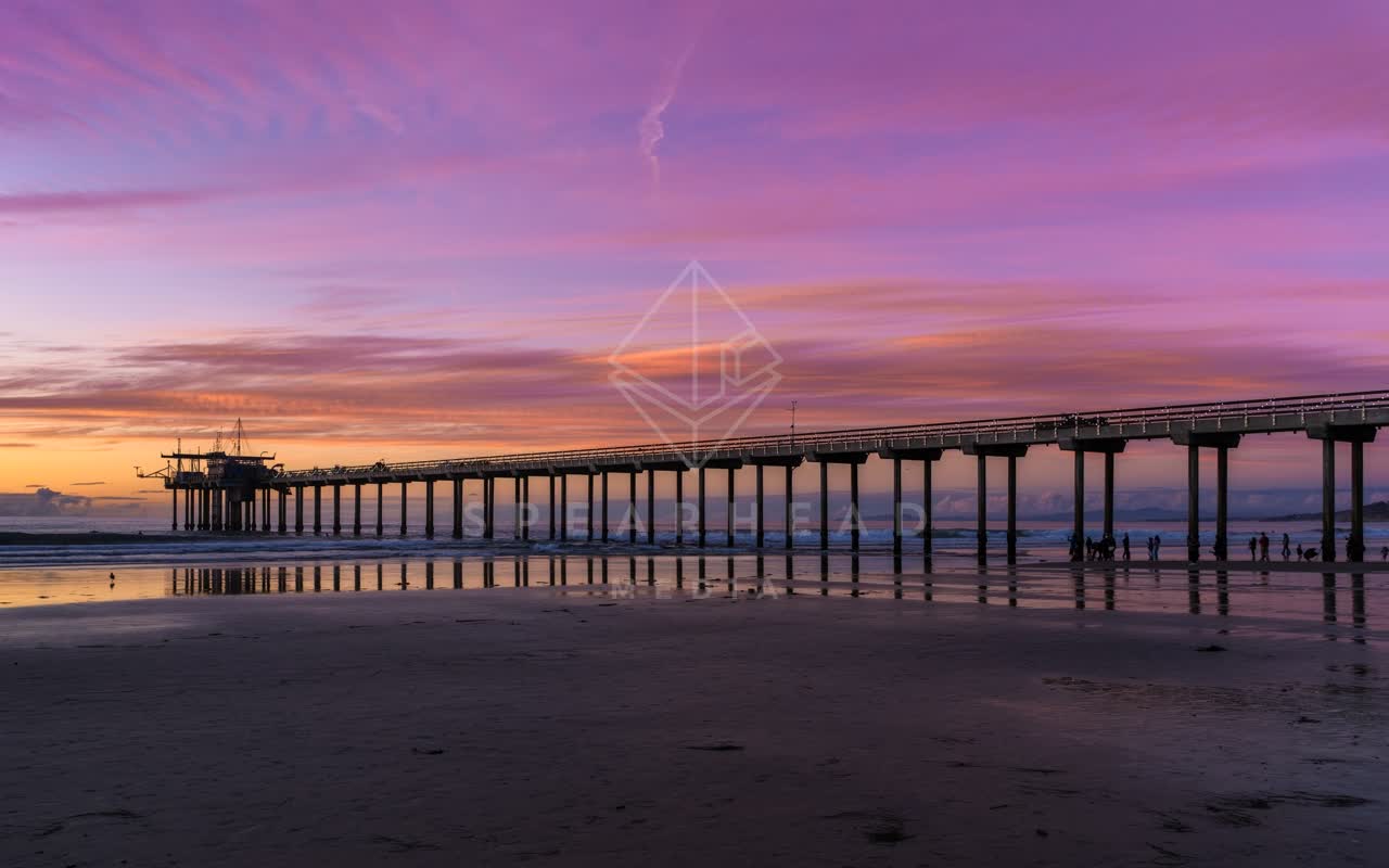 The beach, the pier and the ocean at La Jolla Shores, with people walking.