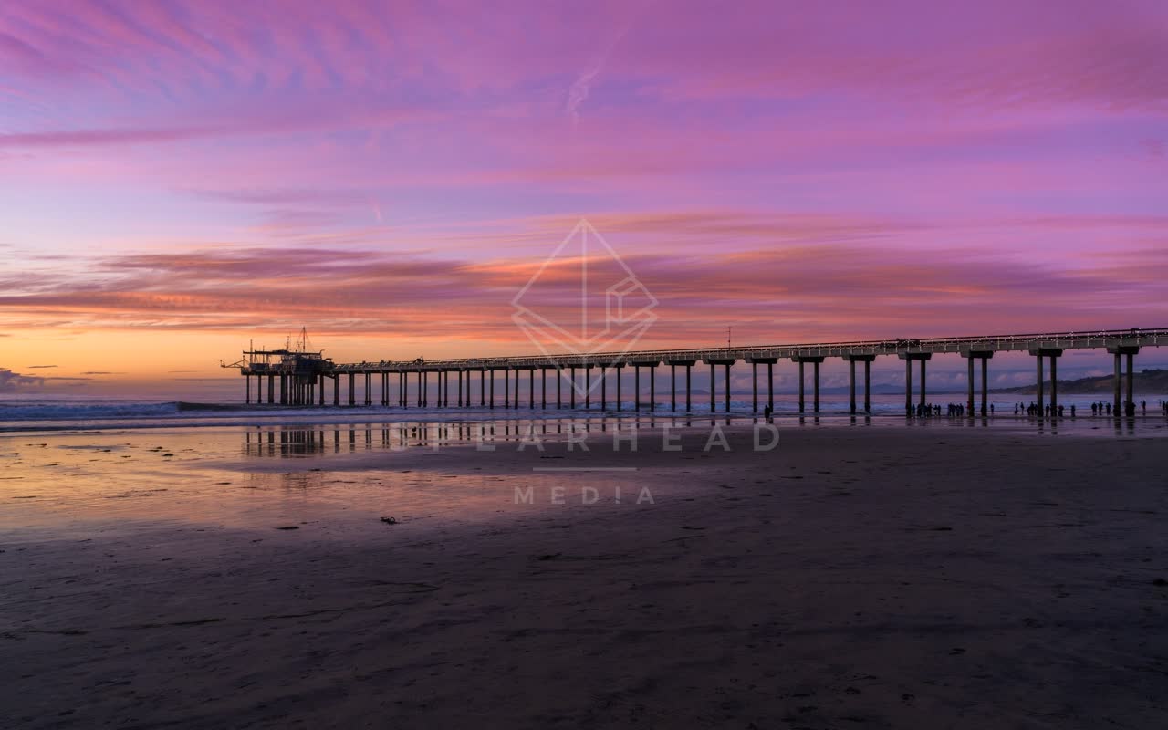 The beach, the pier and the ocean at La Jolla Shores, with people walking.
