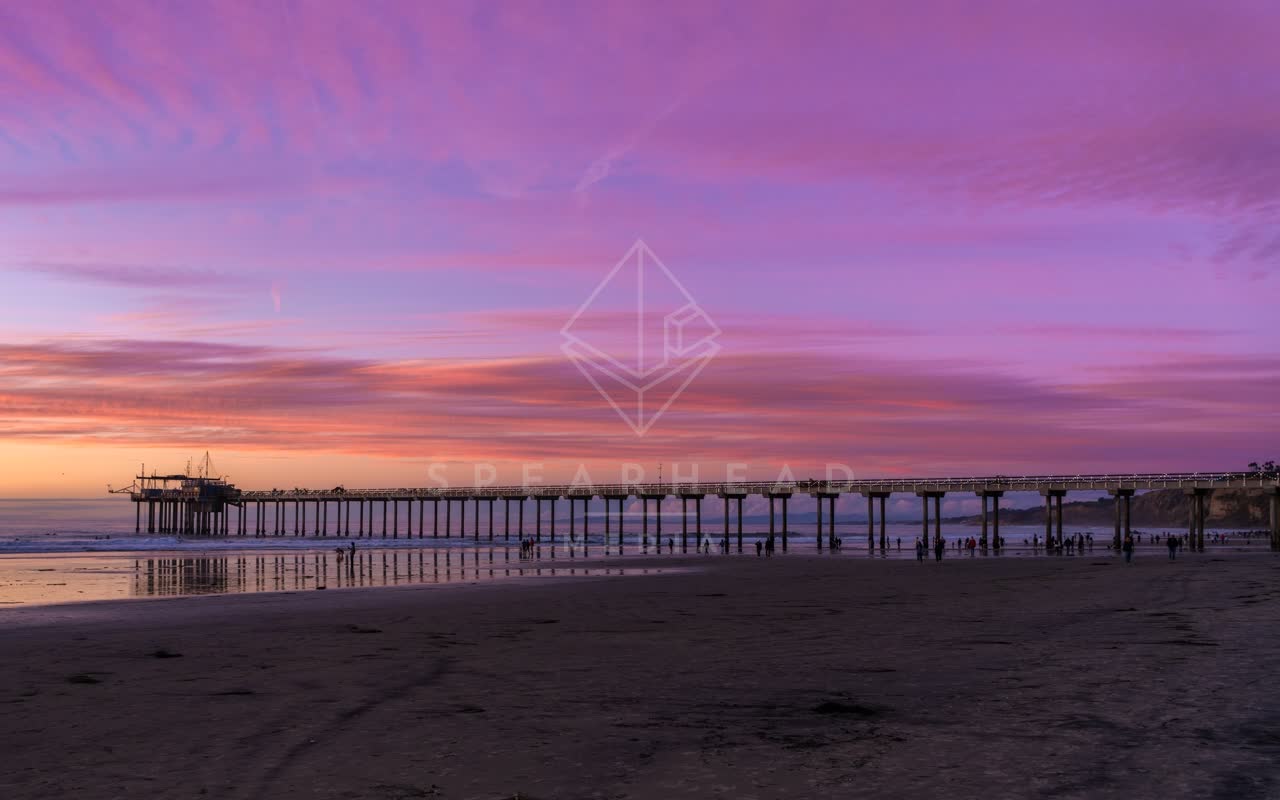 The beach, the pier and the ocean at La Jolla Shores, with people walking.