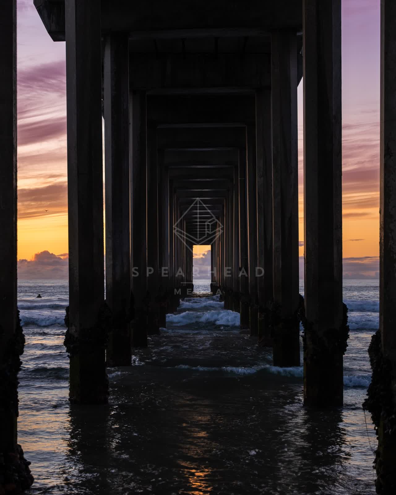 View from the water of the beach, the surf and the pier at La Jolla Shores.