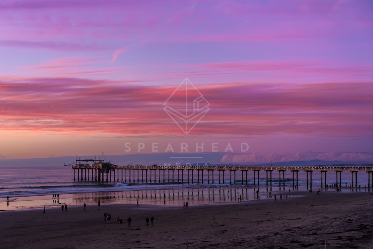 The beach, the pier and the ocean at La Jolla Shores, with people walking.