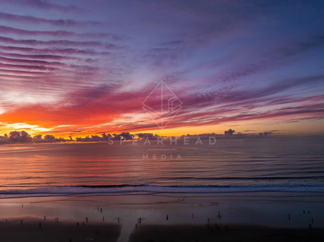 Low aerial view of the beach, the surf and the ocean at La Jolla Shores.