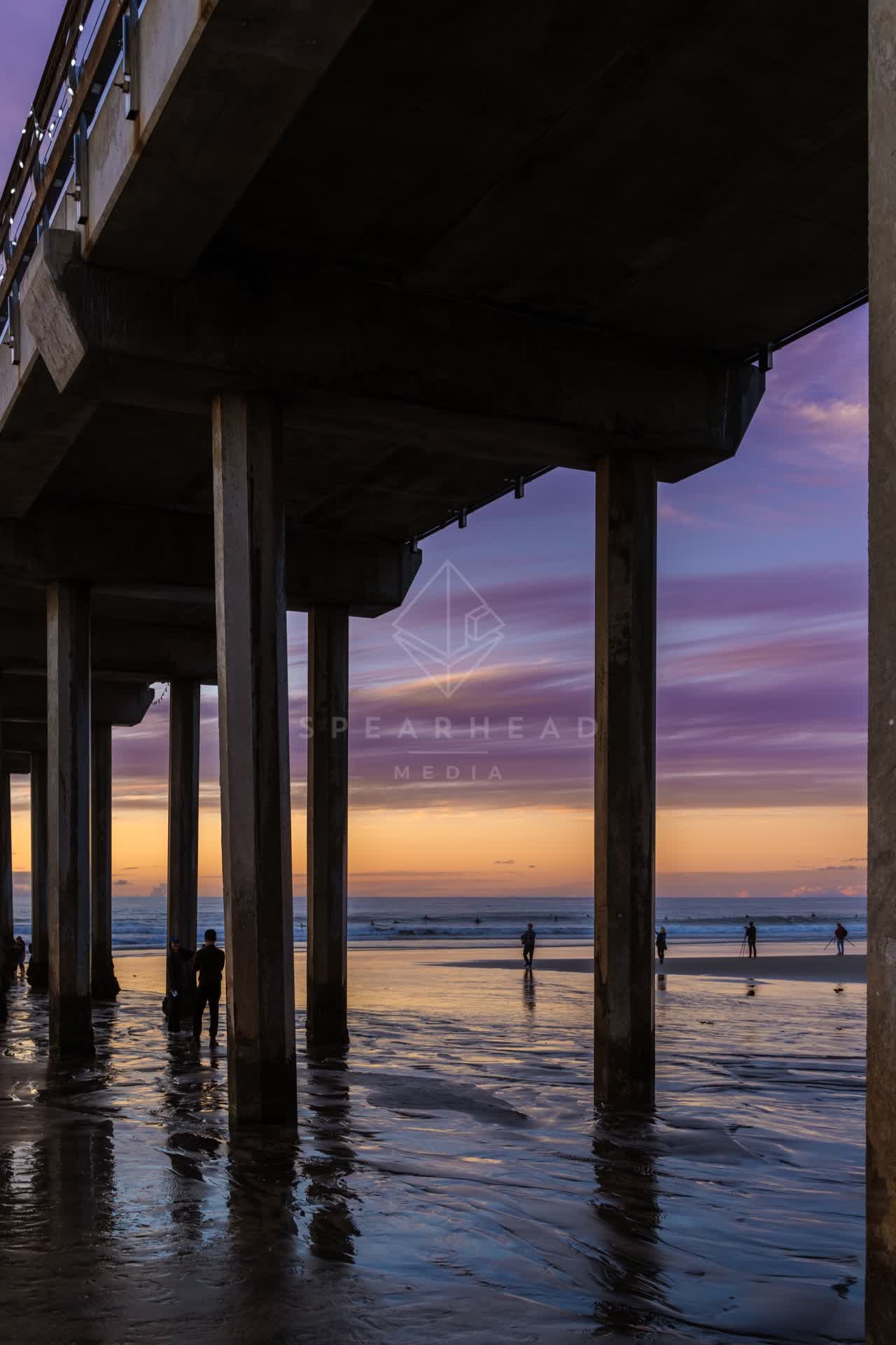 The beach, the pier and the ocean at La Jolla Shores, with people walking.