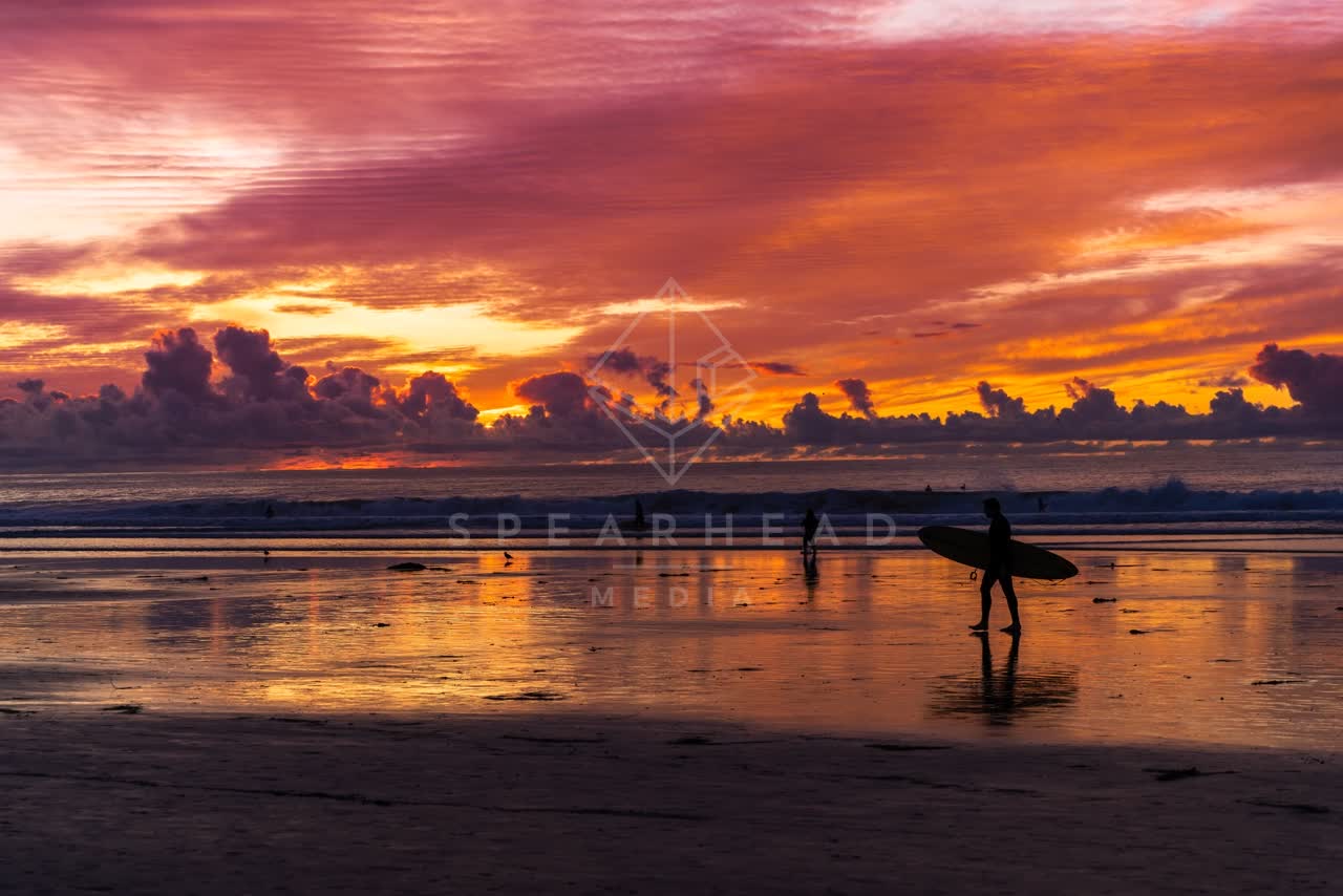 The beach, the surf and the ocean at La Jolla Shores, with people walking.