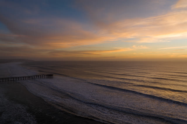 Aerial view of the beach, the surf and the pier in Pacific Beach.