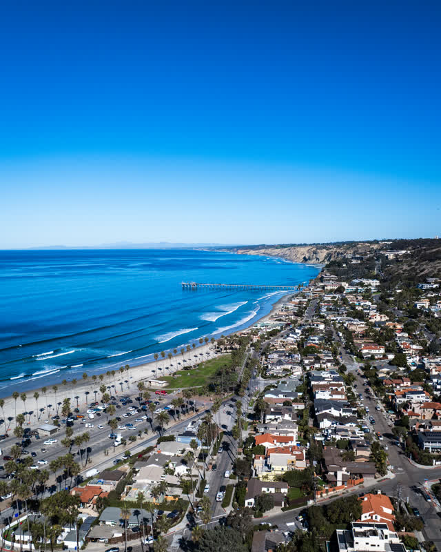 Aerial view of the beach, the surf and the pier at La Jolla Shores.