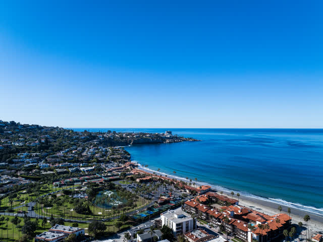 Aerial view of the beach, palm trees and the ocean at La Jolla Cove.