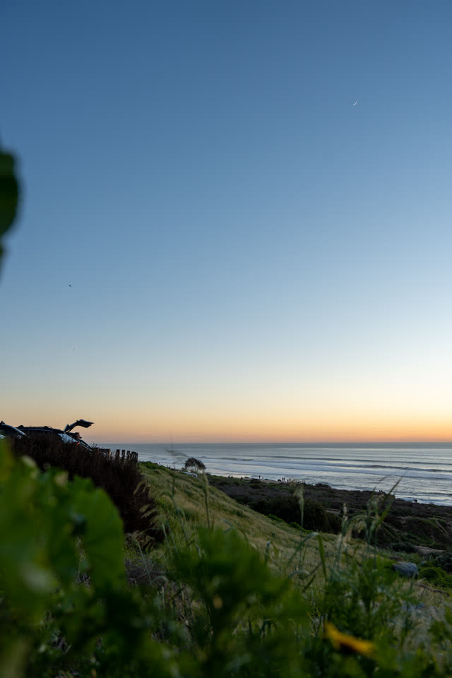 Elevated view of the cliffs, the surf and the ocean at Sunset Cliffs.