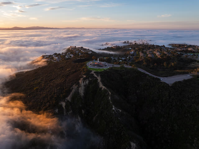 Aerial view of a residential street, homes and open country at Mount Soledad.