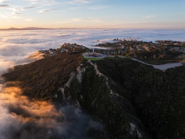 Aerial view of a residential street, homes and open country at Mount Soledad.
