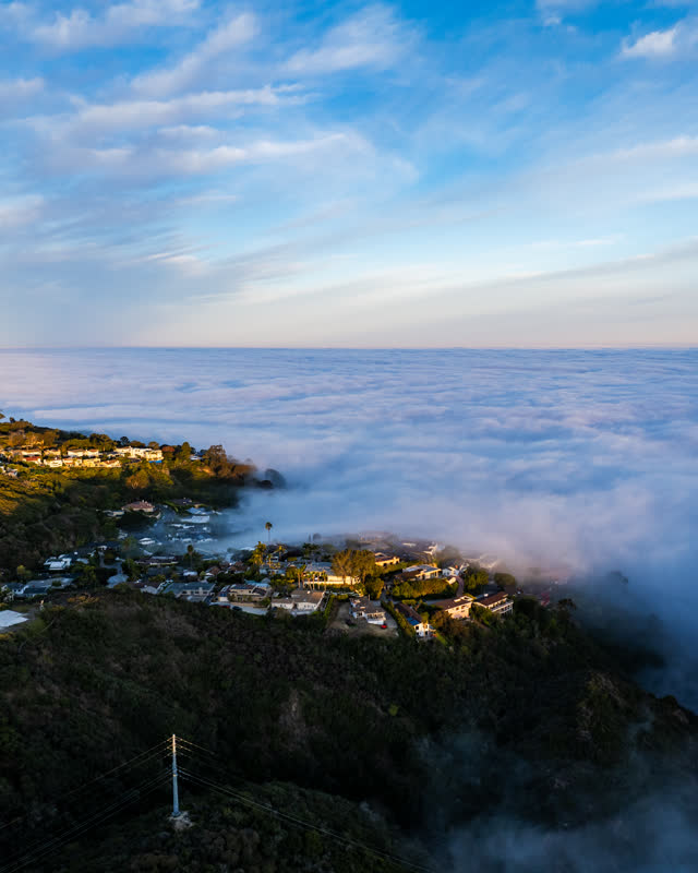 Aerial view of a residential street, homes and the cliffs at Mount Soledad.
