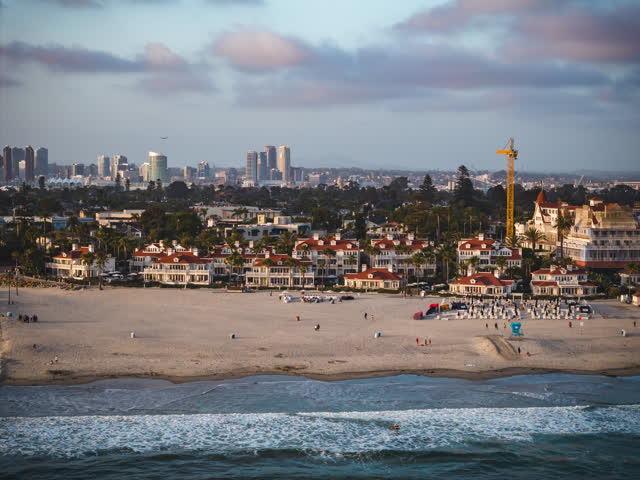 Aerial view of the beach, the skyline and palm trees at Coronado Beach.