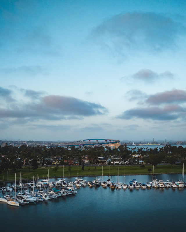 Aerial view of the harbor, the bridge and boats at Coronado Beach, with boats out.