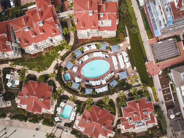 Aerial view of the beach, palm trees and the buildings at Coronado Beach.