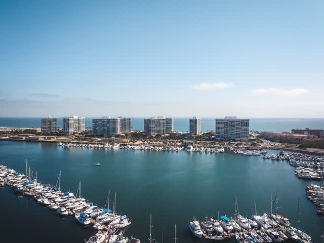 Aerial view of the harbor, boats and the ocean at Coronado Beach, with boats out.