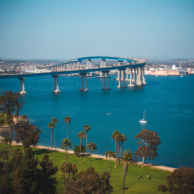 Aerial view of the harbor, the bridge and boats at Coronado Beach, with boats out.