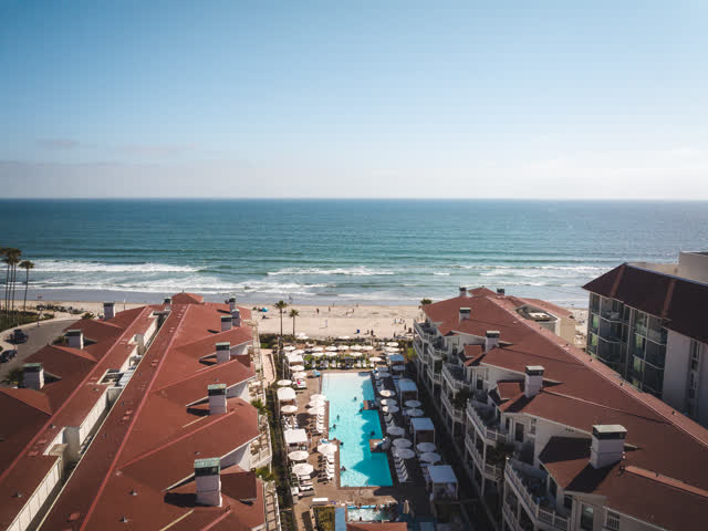 Aerial view of the beach, the surf and the pier at Coronado Beach.