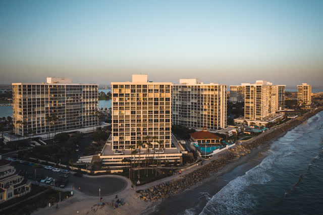 Aerial view of the beach, palm trees and the ocean at Coronado Beach.