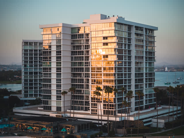 Low aerial view of a residential street, boats and palm trees at Coronado Beach.