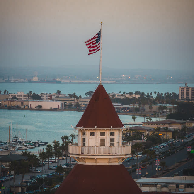 Low aerial view of the harbor, boats and palm trees at Coronado Beach.