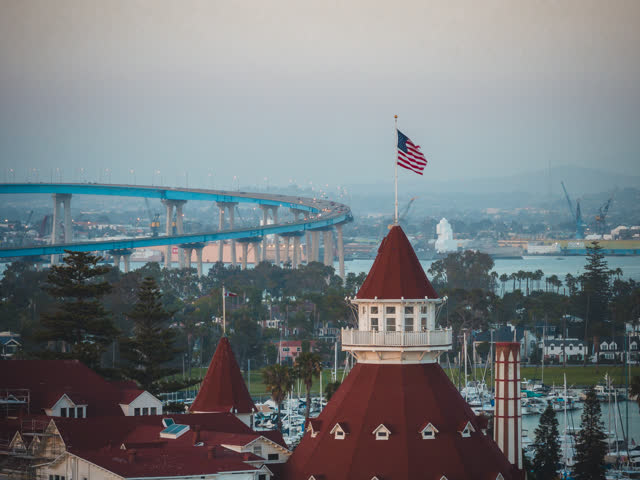Low aerial view of the harbor, the bridge and boats at Coronado Beach.