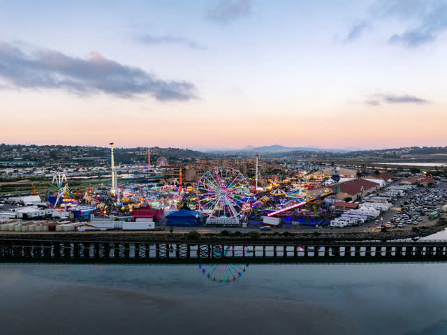 Aerial view of the country inland, traffic and open country in Del Mar, with a crowd gathered.