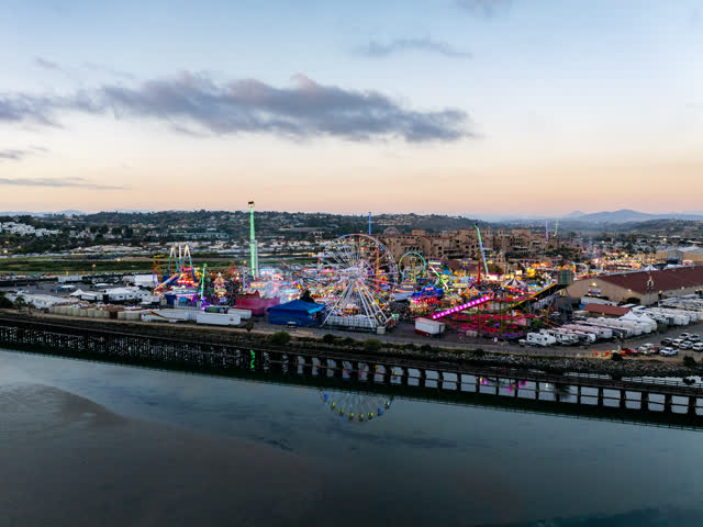 Aerial view of the country inland, traffic and open country in Del Mar, with a crowd gathered.