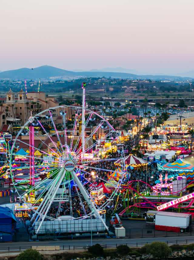 Aerial view of the country inland, the city and traffic in Del Mar, with a crowd gathered.